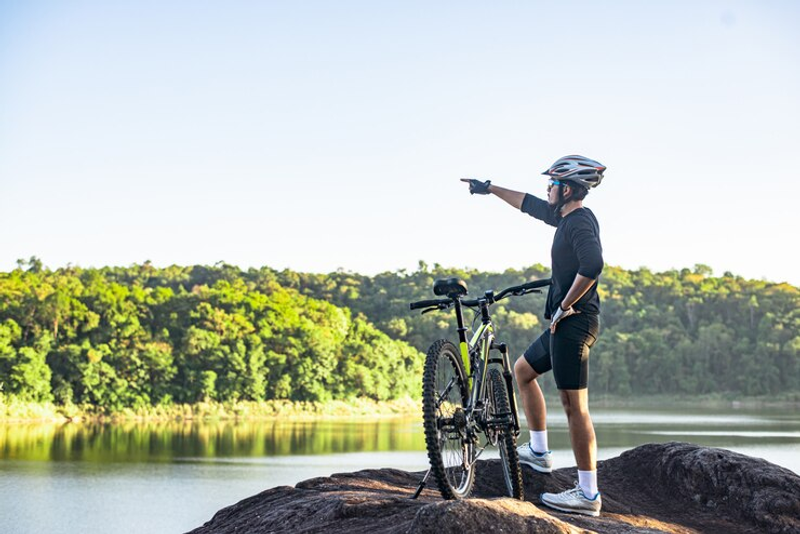 a mountain biker pointing into the distance