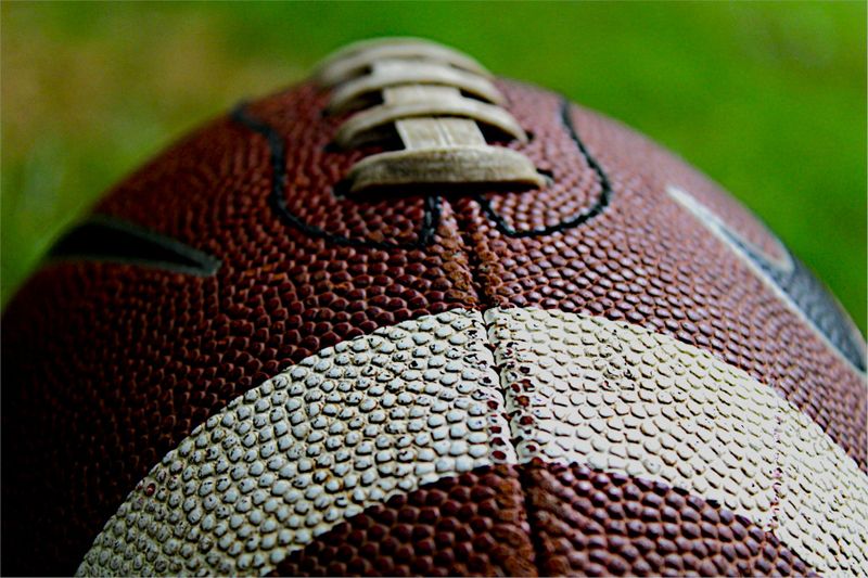 a close up image of a football showing the cross stitching