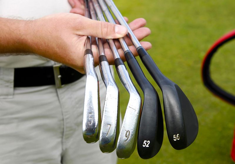 a set of golf clubs with silver and black shafts
