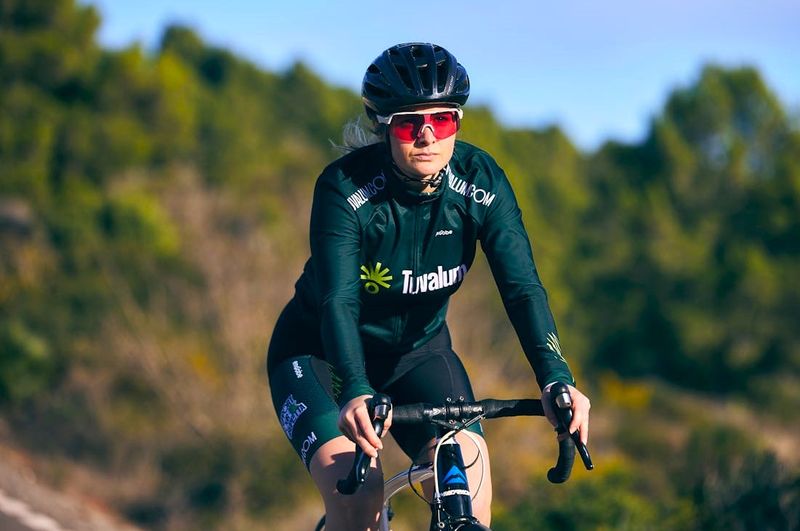 a female cyclist wearing sunglasses