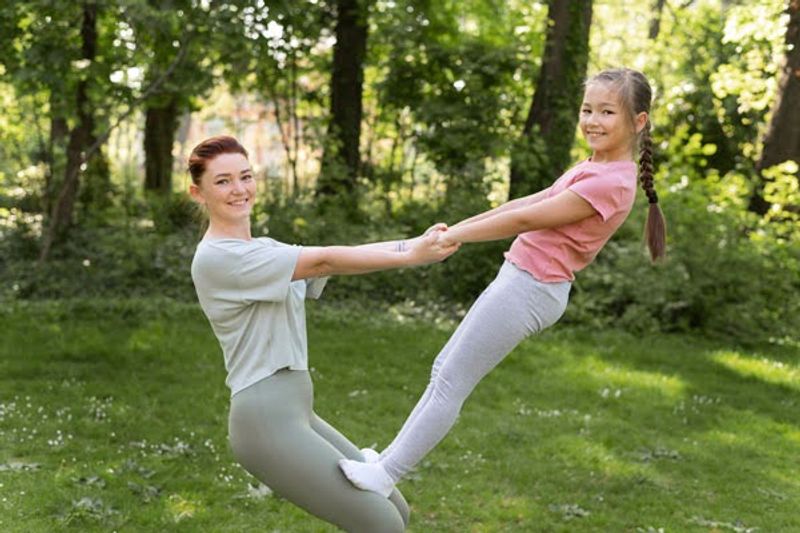 a mother and child in a cheerleading pose