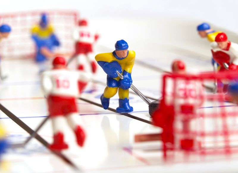 a table top ice hockey game focusing in on one player