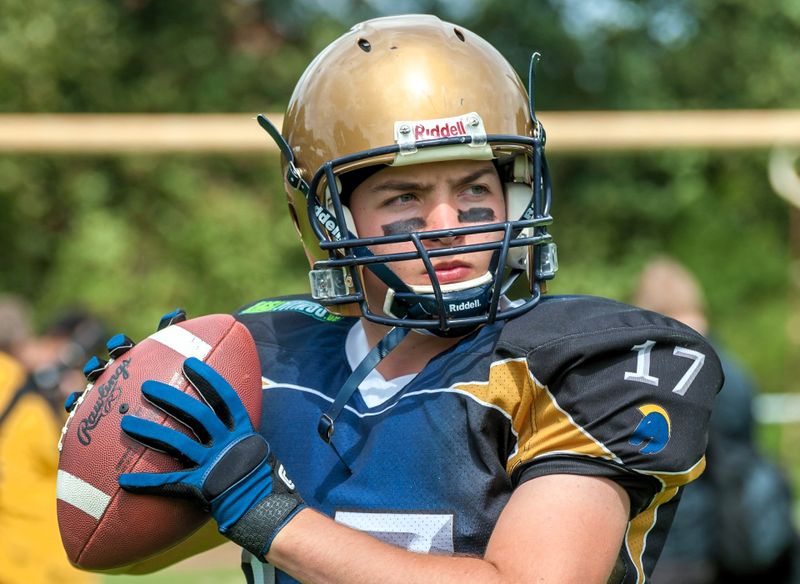 young football player wearing football gloves