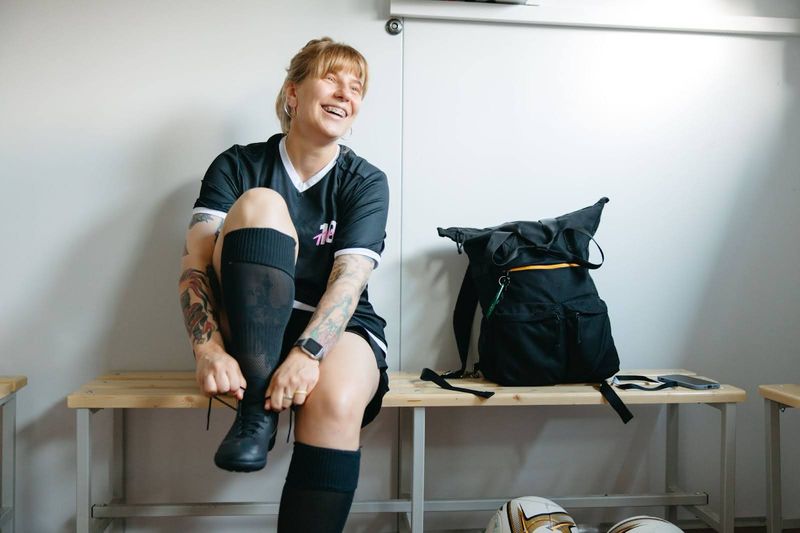 a female soccer player lacing cleats