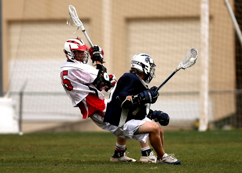 two lacrosse players playing lacrosse