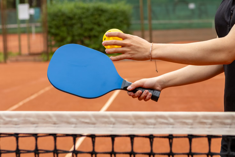 a pickleball paddle and pickleball