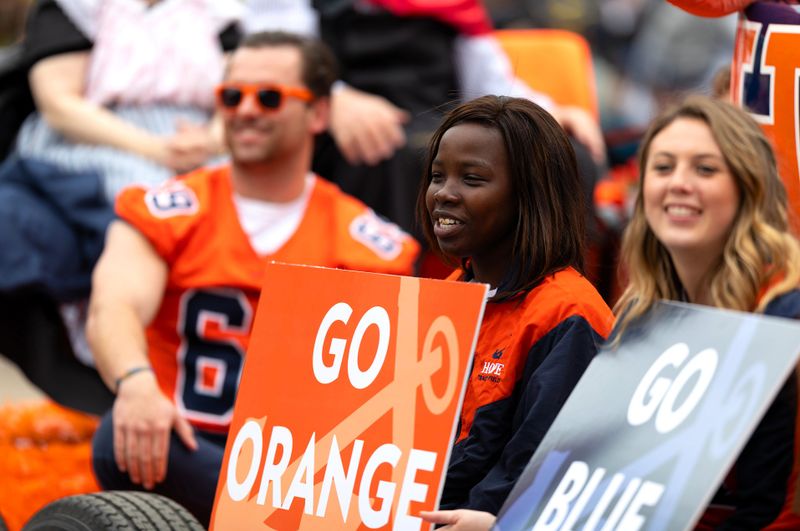 football fans holding fan signs at a football game
