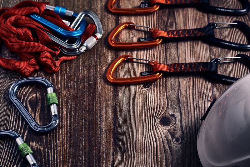 a mix of carabiners on a wooden table