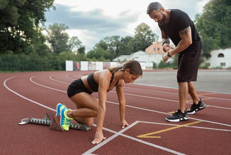 coach offering advice to a track athlete