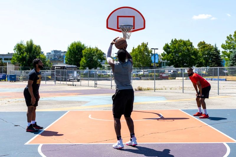 a man taking a free throw on an outdoor basketball court
