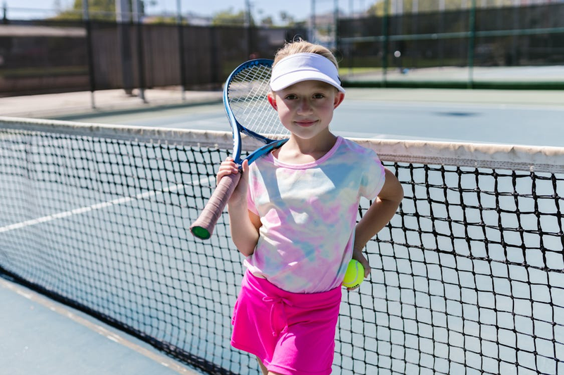 a youth tennis player holding a tennis racket