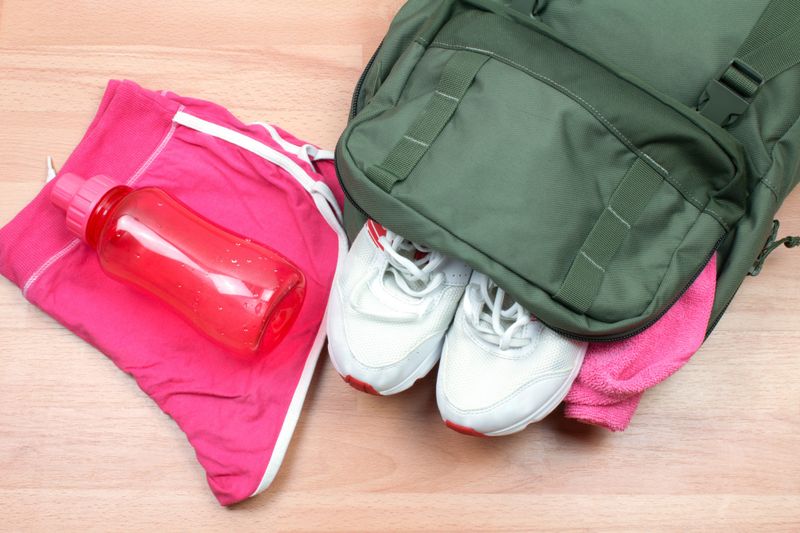 a green dance bag next to pink shorts and athletic shoes