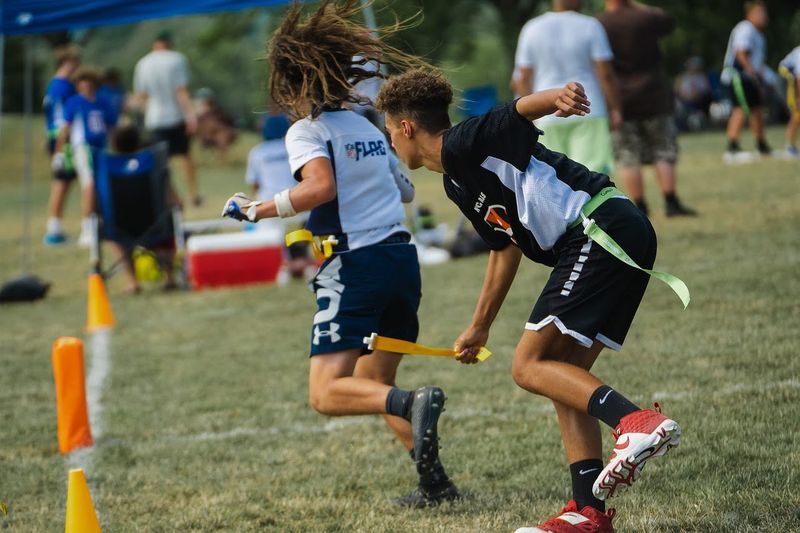 a flag football player grabbing an opponents flag