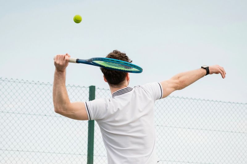 a man about to hit a tennis serve