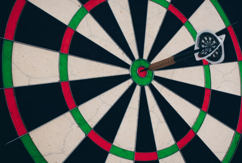 a single dart in the bullseye on a dartboard