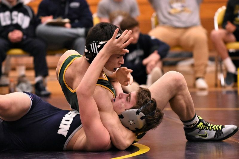 wrestler has his opponent in a headlock