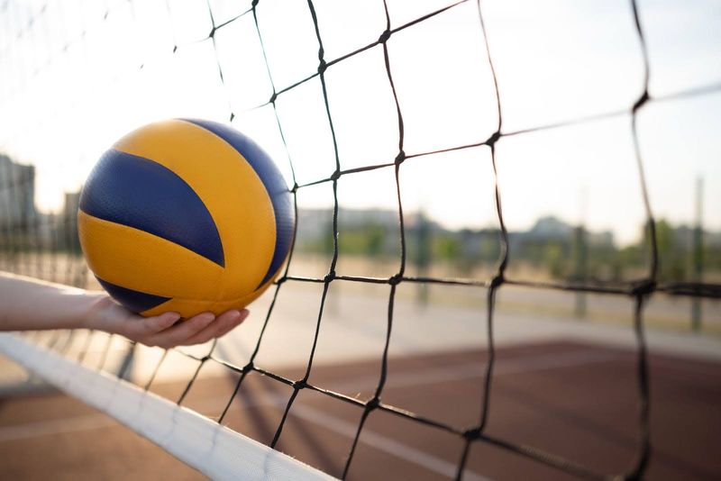 A volleyball in front of a net