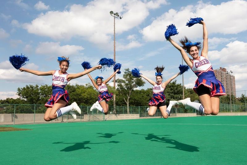 a group of cheerleaders jumping into the air