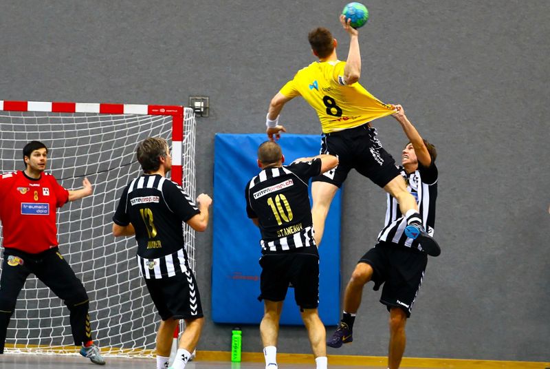 a handball player taking a shot to score a goal