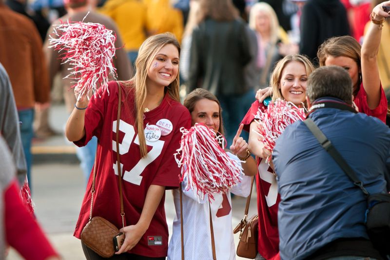 a group of football fans holding team pom poms