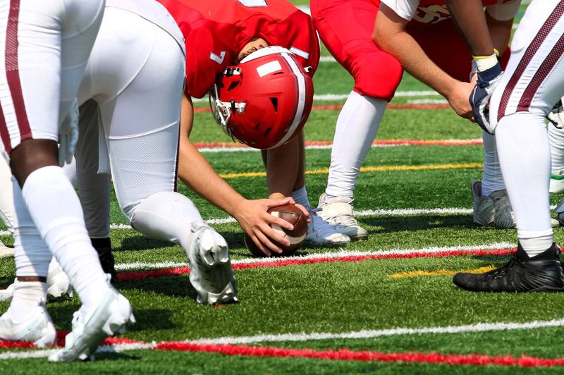 football players about to hike the ball from the line