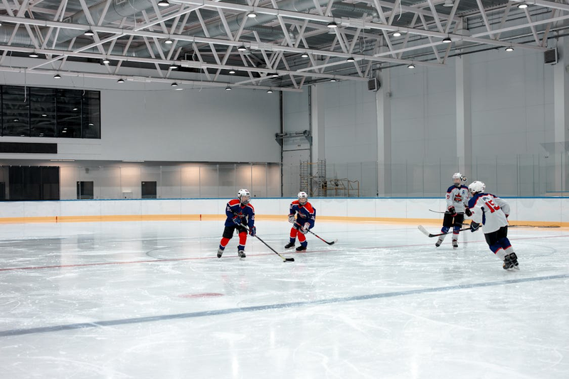 four hockey players on an ice hockey rink