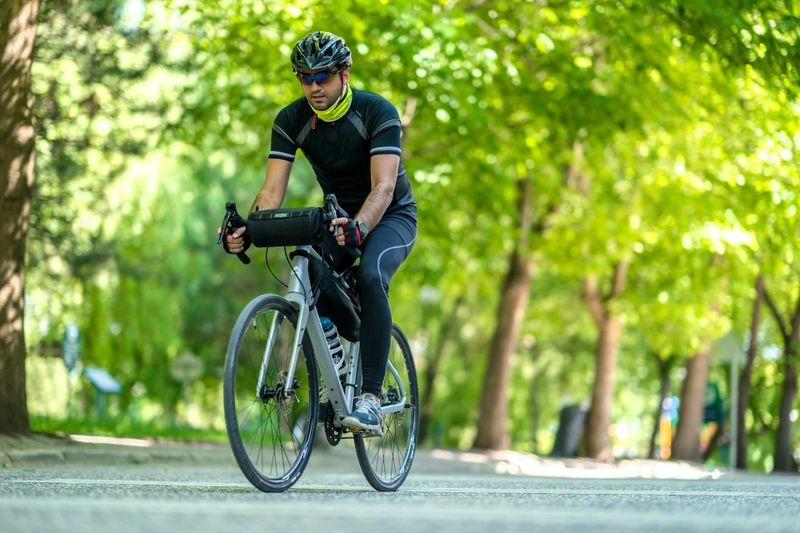 a middle aged man cycling along a road